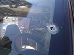 Bullet hole in windshield.